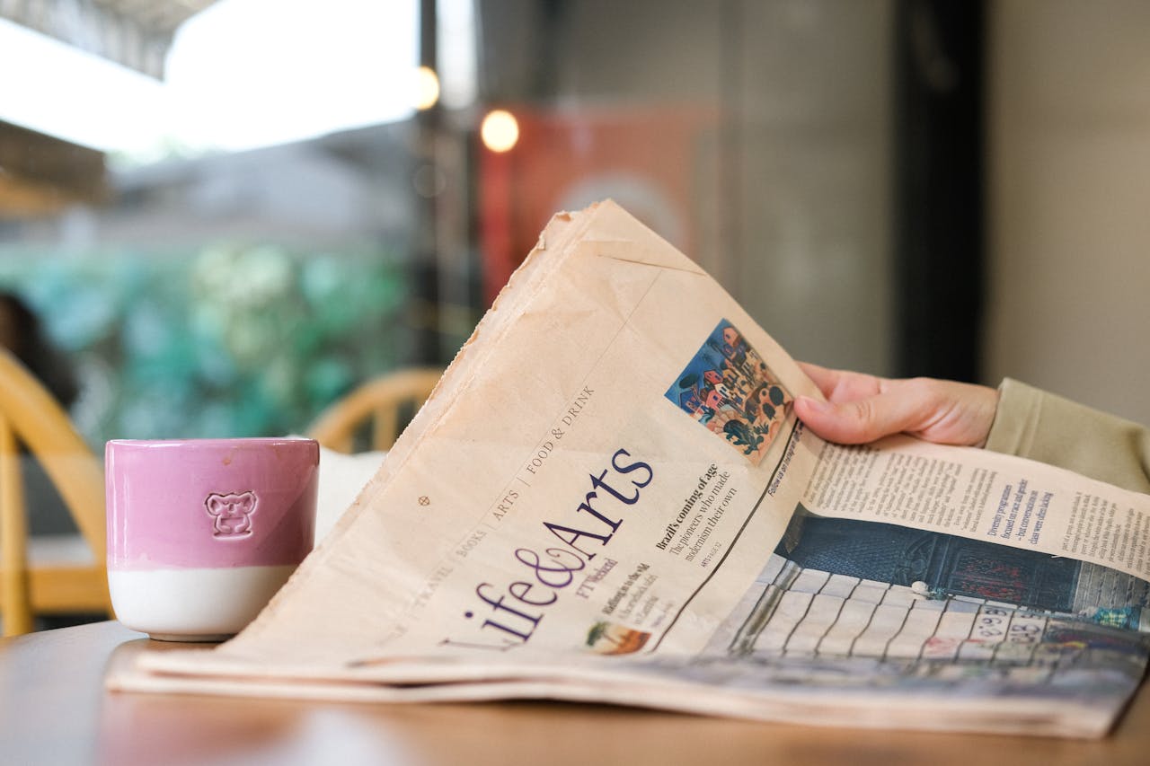 portfolio-05 A person enjoying coffee while reading the Life & Arts section of the newspaper.